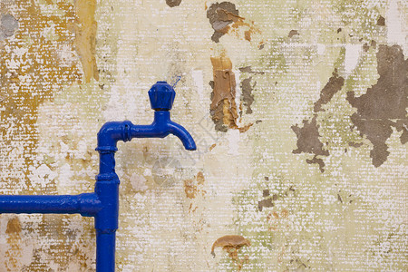 水暖墙纸工业的旧漆成蓝色水龙头和管道以纹质墙壁背景复制空间图片