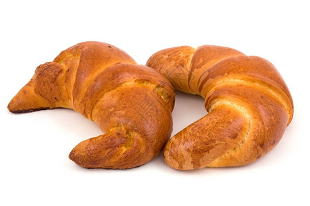 金子两个羊角面包孤立在白色上零食甜的图片
