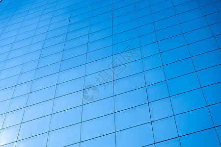 抽象的蓝色玻璃窗办公大楼背景太阳公司的图片