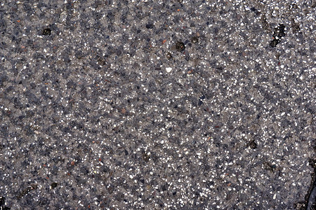 粗糙的岩石城市道路地面上的可塑石块结图片