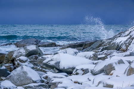 自然豪克兰冬天海洋岸线上冲浪喷洒的雪覆盖石块喷洒到该海滨的水雾背景图片