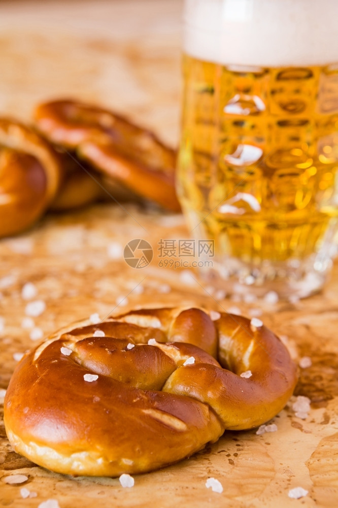 巴伐利亚糕点面包咸熟的辣椒和啤酒加在防油纸上的啤酒咸熟烤脆饼和啤酒加在图片