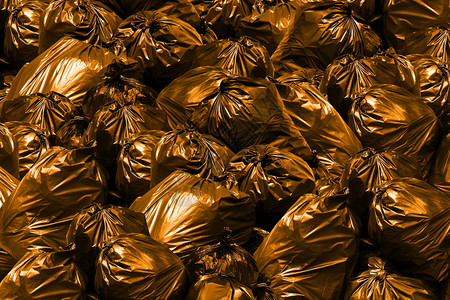 背景堆垃圾袋橙色Bin垃圾塑料袋堆衬垫回收污垢图片