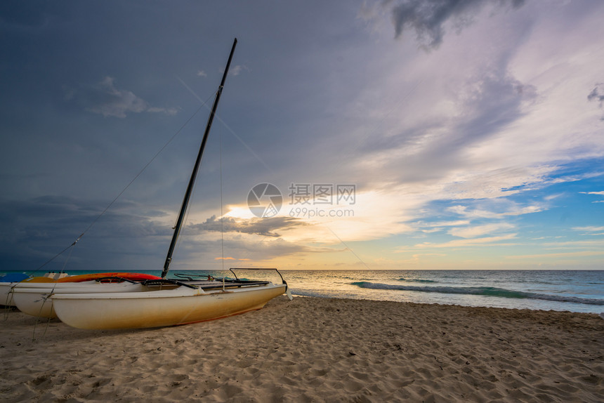 晚上旅游古巴瓦拉德罗海滩日落时的Catamarans夏天图片