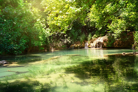 野餐溪流结石库尔苏努自然公园和瀑布与明绿湖水夏季风景安塔利亚土耳其库尔苏努自然公园及湖泊瀑布背景图片