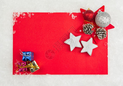 浪漫的喜庆锥体红圣诞纪念卡上面有小礼物盒和雪上星图片