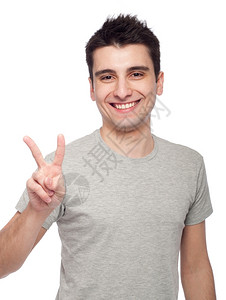 积极的快乐年轻英俊男子显示胜利的手指标志孤立在白色背景上打手势高清图片素材