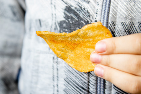 土豆糖果孩子手里拿着薯条特写垃圾食品孩子手里拿着薯条垃圾食品可爱的图片