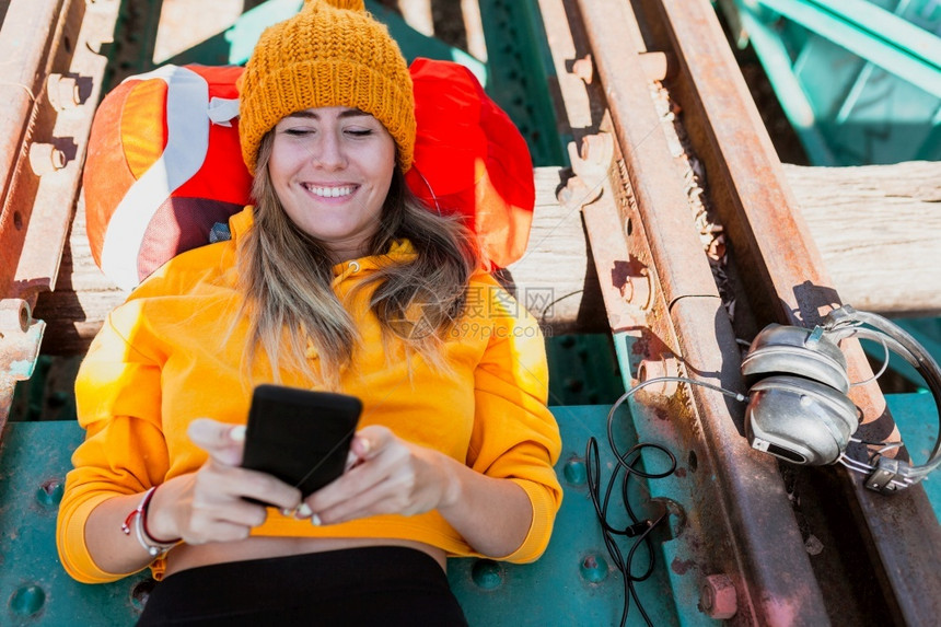休息桥探索女人在废弃铁路轨道上使用智能手机的女子图片