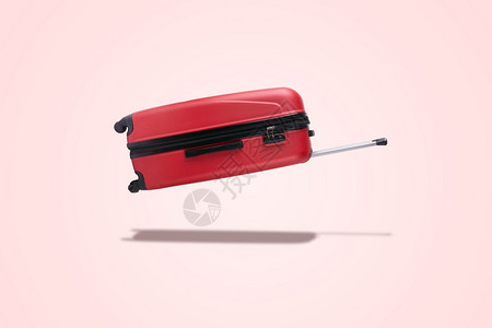 年夜饭预订中公文包红色的手提箱在粉红背景的空气中飘浮手提包设计图片