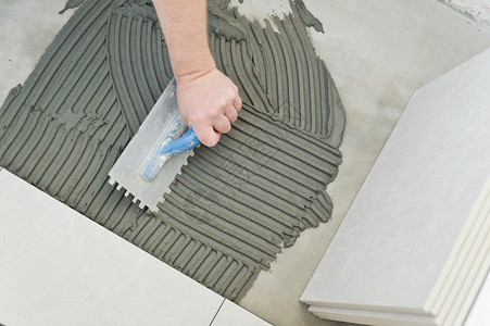 将陶瓷砖铺在水泥地板上以准备打白地板瓷砖的铸造工事在职浴室安装背景图片