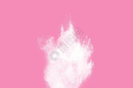 粉末状降低充满活力粉红背景涂料Holi的白粉末爆炸节日设计图片
