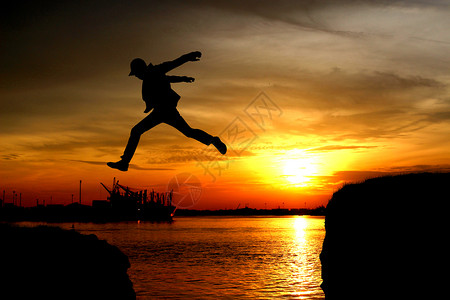 一个人从悬崖上跳下夏天日落跃图片