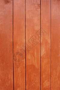 肮脏的垂直平行木板用红色漆成栅栏墙背景图片