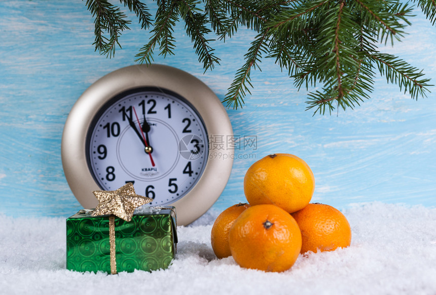 背景有礼物盒和橘子在雪上时钟装饰庆祝柑橘图片