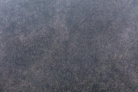 灰红花岗岩的斑点壁纹理灰红花岗岩的墙纹理地质学老的灰色背景图片