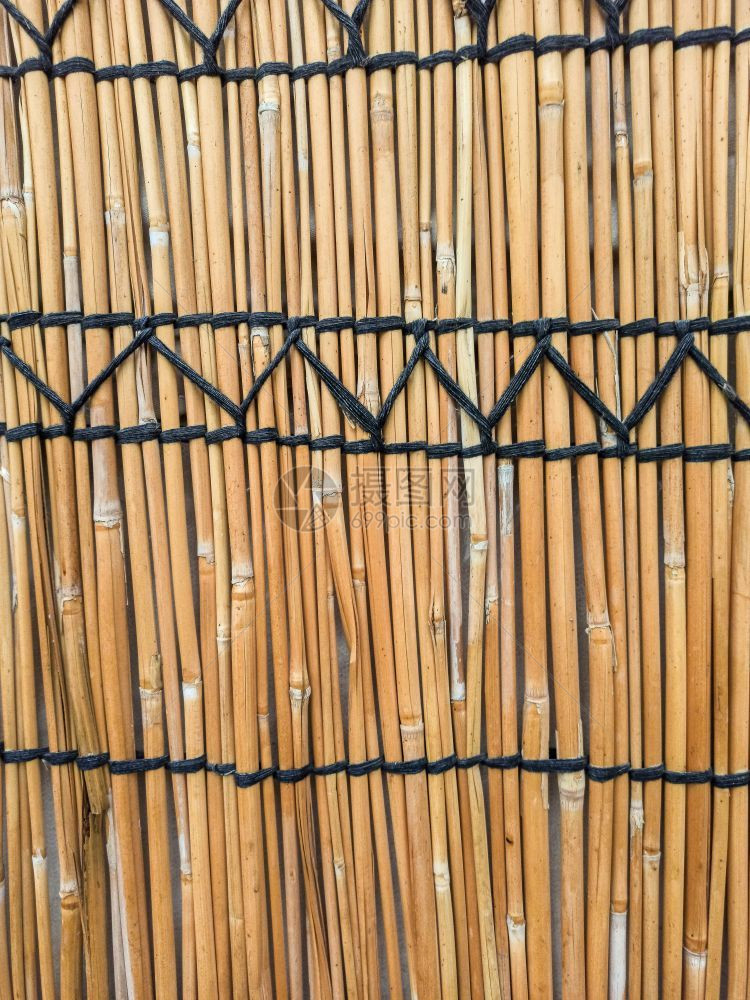 墙的纹理由干草制成紧闭着棕榈色的小屋图片