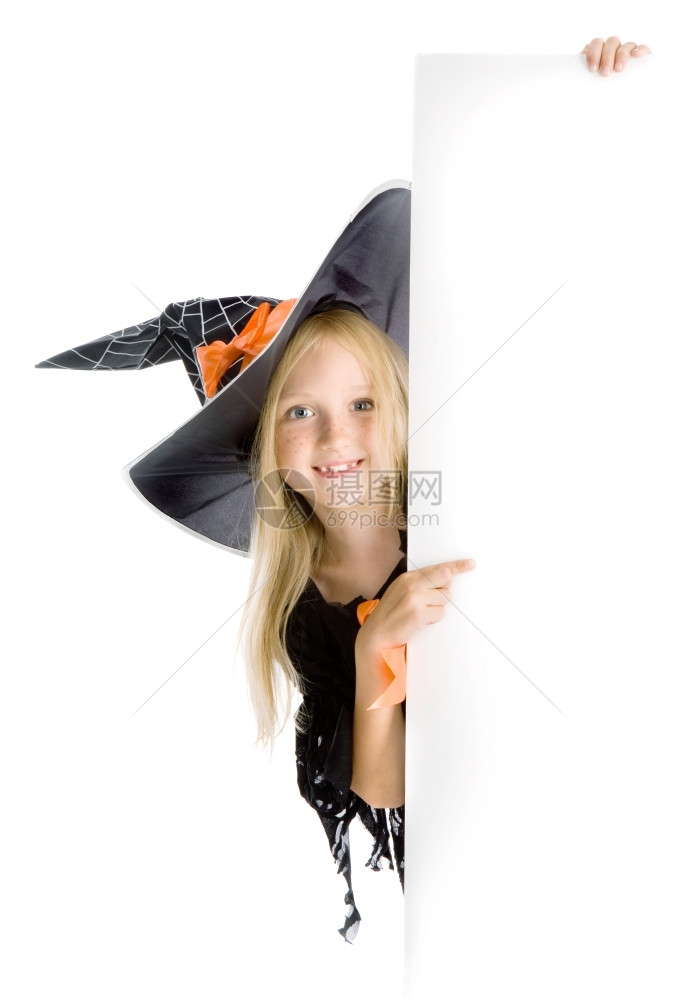 垂直的指点美丽笑着微小女孩长金发在服装指着标志黑帽与网蜘蛛和橙色弓空间眼睛图片