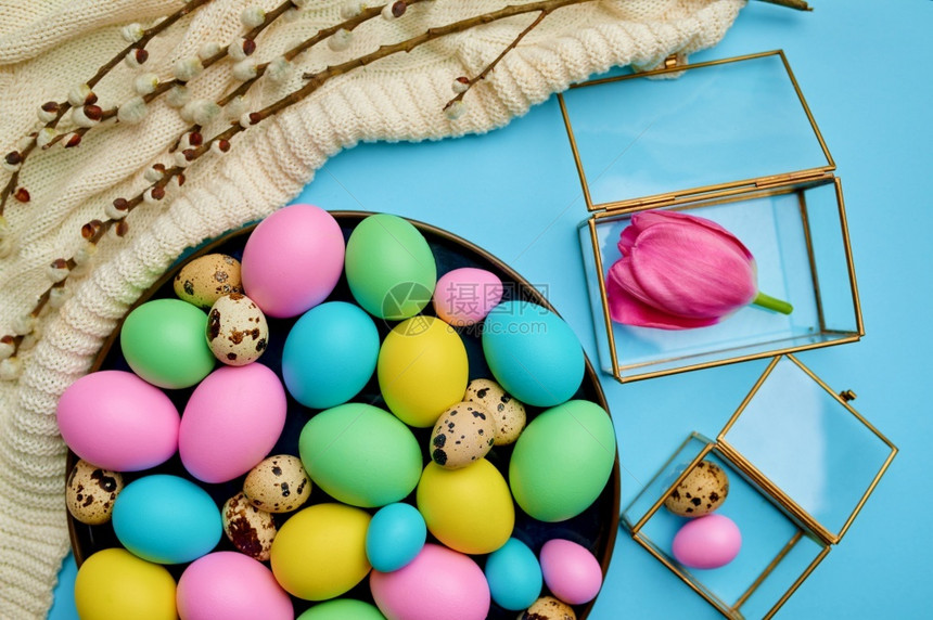 假期oopicapi四月彩色东蛋和蓝底面的花卉装饰活动春季节日庆祝活动传统标志彩色东蛋和花岗装饰等有多种色彩的东鸡蛋和花卉装饰图片