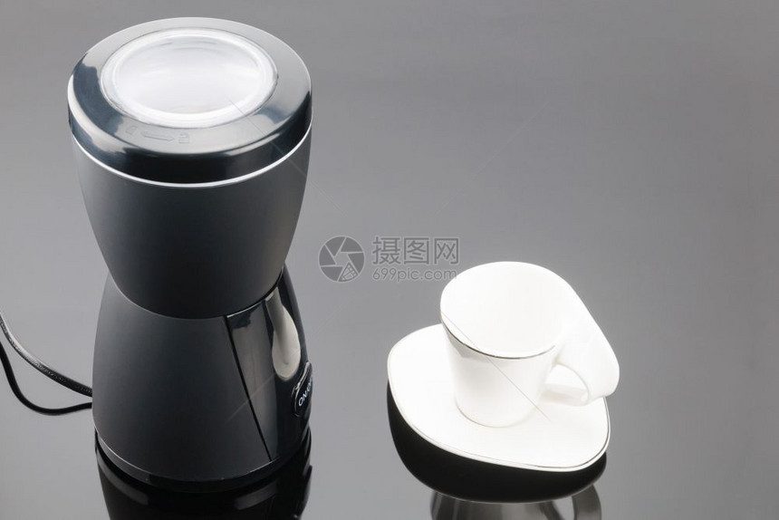 混合电气按钮灰镜背景上带咖啡杯的黑研磨机灰镜背景上带咖啡杯的研磨机图片
