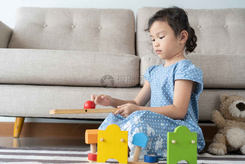 在客厅里玩积木游戏的小女孩图片