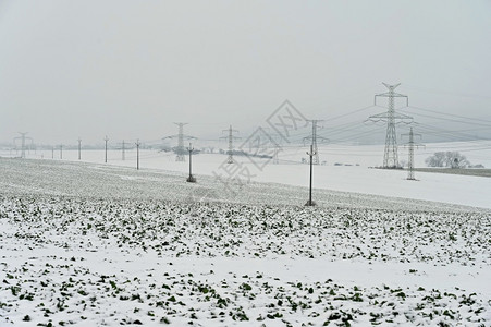 团价技术行业建造冬季风景中的高电压塔冬季雪价昂贵的供暖以及欧洲电价不断上涨等情况背景