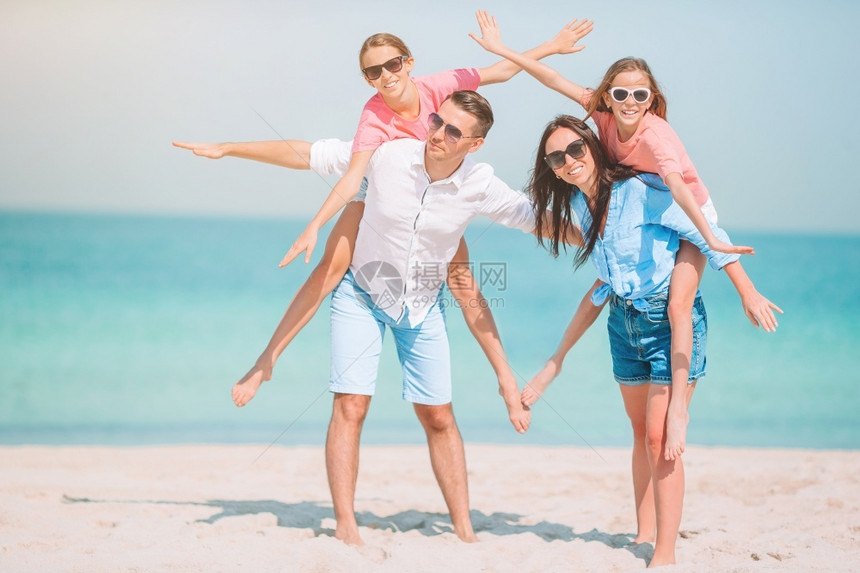 快乐的水父母和子女在海滩上的家人玩得开心度假的年轻家庭有很多乐子啊喜悦图片