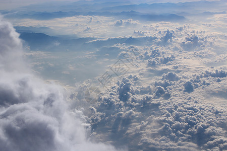 风景优美蓬松的夏天云上飞行机窗外的白云全景飞过下方的美丽天堂全景图片