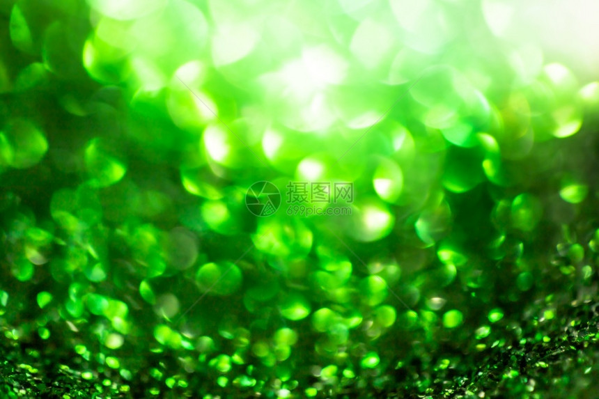 模糊闪亮的宇宙绿色亮年光灯在节庆和祝活动上不注重背景图片