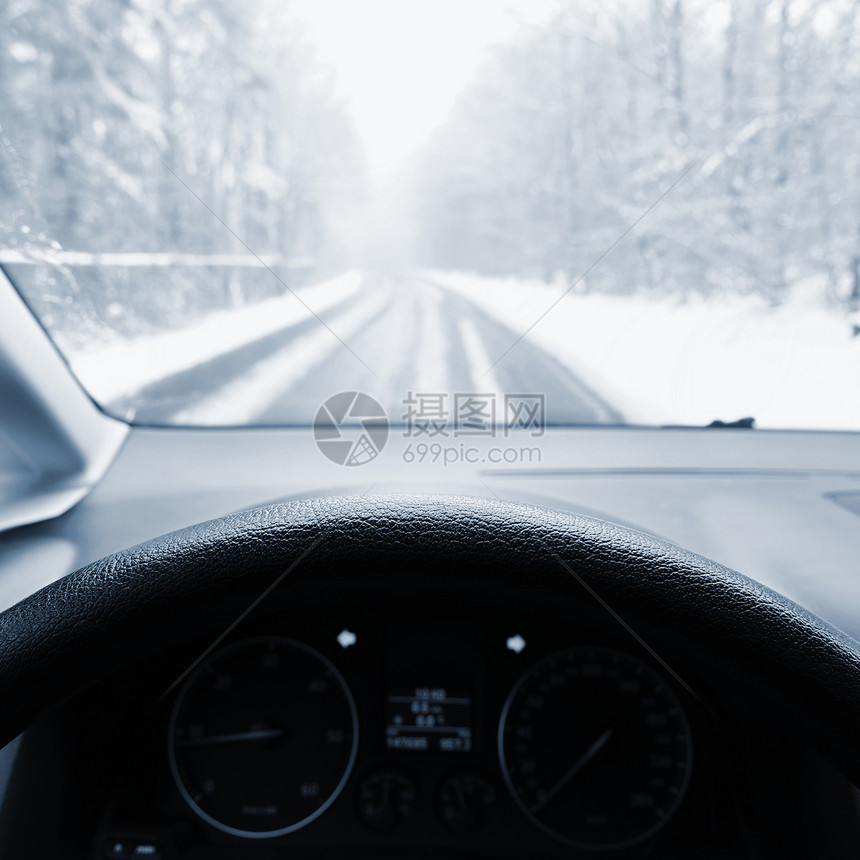 内部的现代仪表盘驾驶员在冬季风景中驾驶汽车从一辆内部驶走一条滑雪路上的司机眼目视该车为冬季安全驾驶概念图片