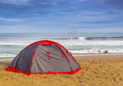 天空海边沙滩上的帐篷远足活动图片