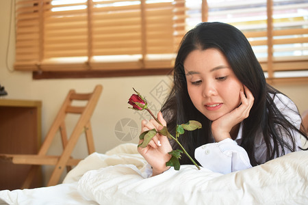 年轻的唤醒婚礼有玫瑰花的年轻美女睡在卧室图片