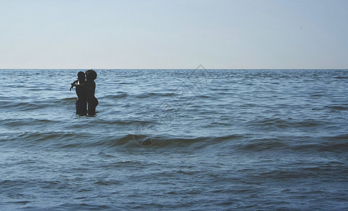 吸引人的两在荷兰席凡宁恩海滩拥抱蓝天碧晴两人拥抱蓝朋友们快乐的图片