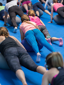 合身女孩在健房做大球伸展健身运动女孩在健身房做大球伸展健身运动强的康图片