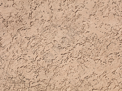 水泥沙子洞中风Beige深黑墙壁纹理背面景松散墙上的沙粉石膏沙子的松散纹理滴设计图片