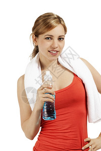 健康茶点年轻运动女青有一瓶水轻微笑的运动女员白本上有一瓶水闲暇图片