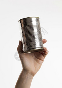 蓝色的银一顿饭握着手的锡罐子美丽照相手拿着锡罐子高清图片
