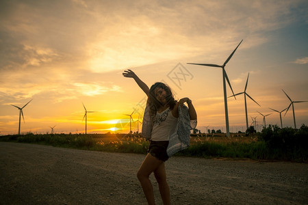 螺旋桨黄色的涡轮日落时分在泰国风农场张贴年轻女图片