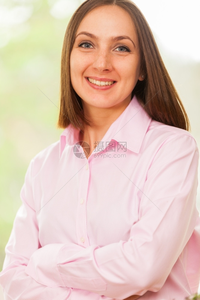 专业的女士工作穿着粉红色衬衫的年轻笑女商业妇的肖像图片