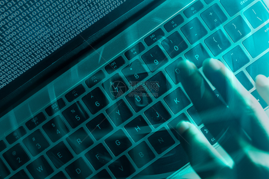 黑色的阴影技术计算机程序员或黑客在笔记本电脑键盘上打印代码以破入秘密组织系统图片