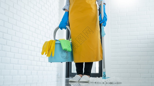 工人年轻的打扫青女管家或拖把清洁地板上洗衣涤戴防护手套家务清洁服图片