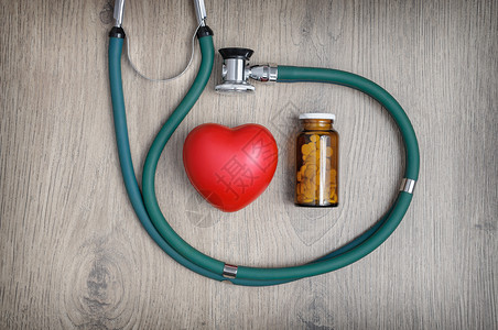 心脏病学考试一个听诊器杯药片和红心形的包头视镜桌子背景图片