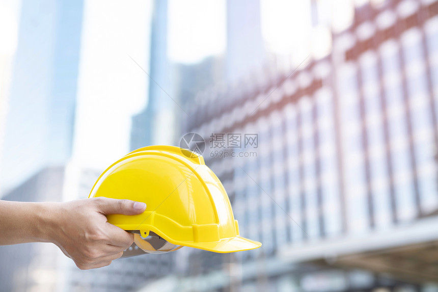 工作地点建造拥有黄色安全顶帽子的物证信托小组建筑工程师负责安装黄盔图片