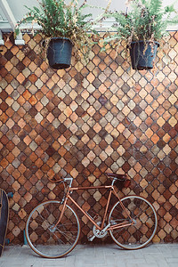 车停在古老的马赛克墙上旧自行车生锈户外屋图片