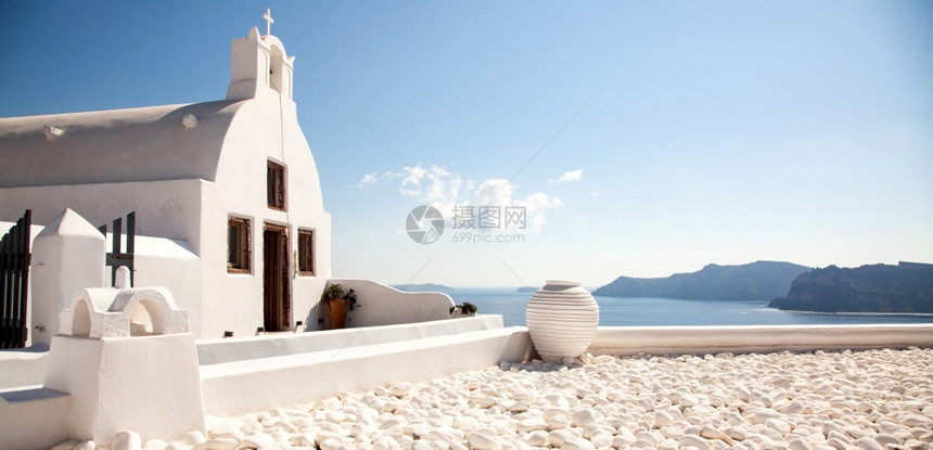 镇天空日落Caldera岛爱海沿岸传统白色建筑的风景旅行背圣托里尼图片