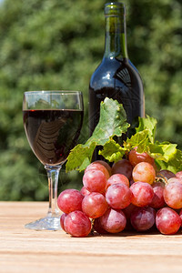 美食品尝复古的黑葡萄酒杯配有新收获的葡萄图片