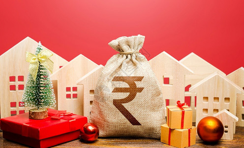 订金包新年气氛中的印度卢比钱袋和房屋投资吸引力增加繁荣银行存款信贷促销提供圣诞节冬季假期抵押贷款建筑物背景图片