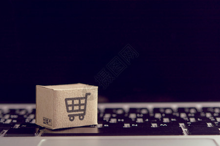 电子商务业在线购物在网上的笔记本电脑键盘购物服务上贴有车标志的纸箱或包裹提供在家分娩市场零售高清图片素材