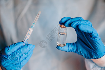丁腈手套胰岛素医生护士科学家用蓝硝酸手套携带疫苗和注射器用于预防免疫和治疗冠状菌感染Corona感染化学实验室背景