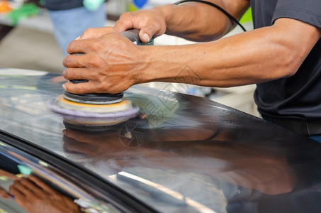 负责打磨涂层汽车擦面的男子在车面后会帮助消除车面表的污染物在擦车面之后将发光外部的维护洗涤图片